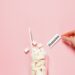 Glass of sugar cubes with diabetes label on pink background. prediabetes vs diabetes